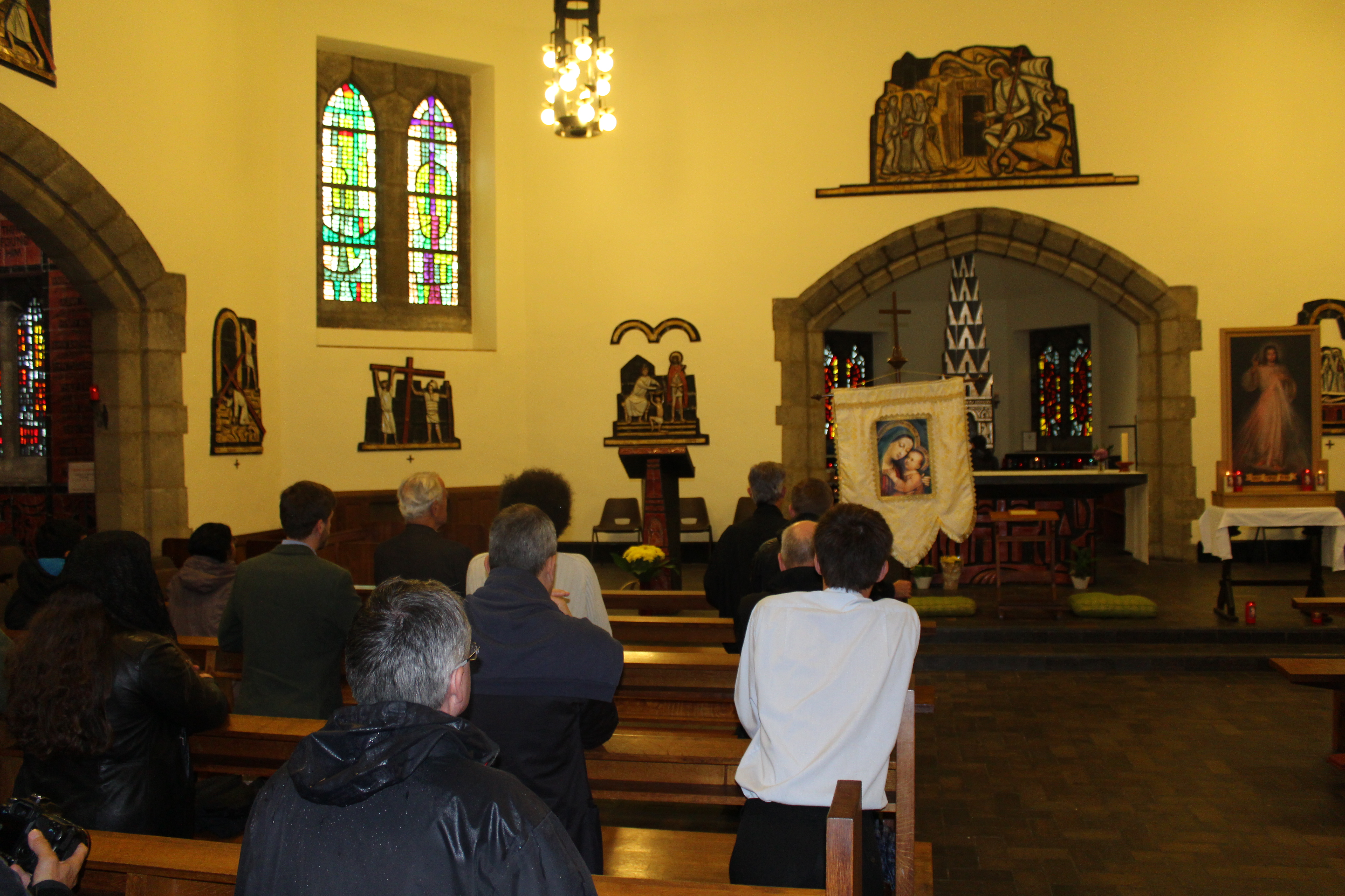 Reciting the Rosary in front of the reliquary of St Simon Stock in Aylesford. The reliquary can be seen in the background behind the altar. 