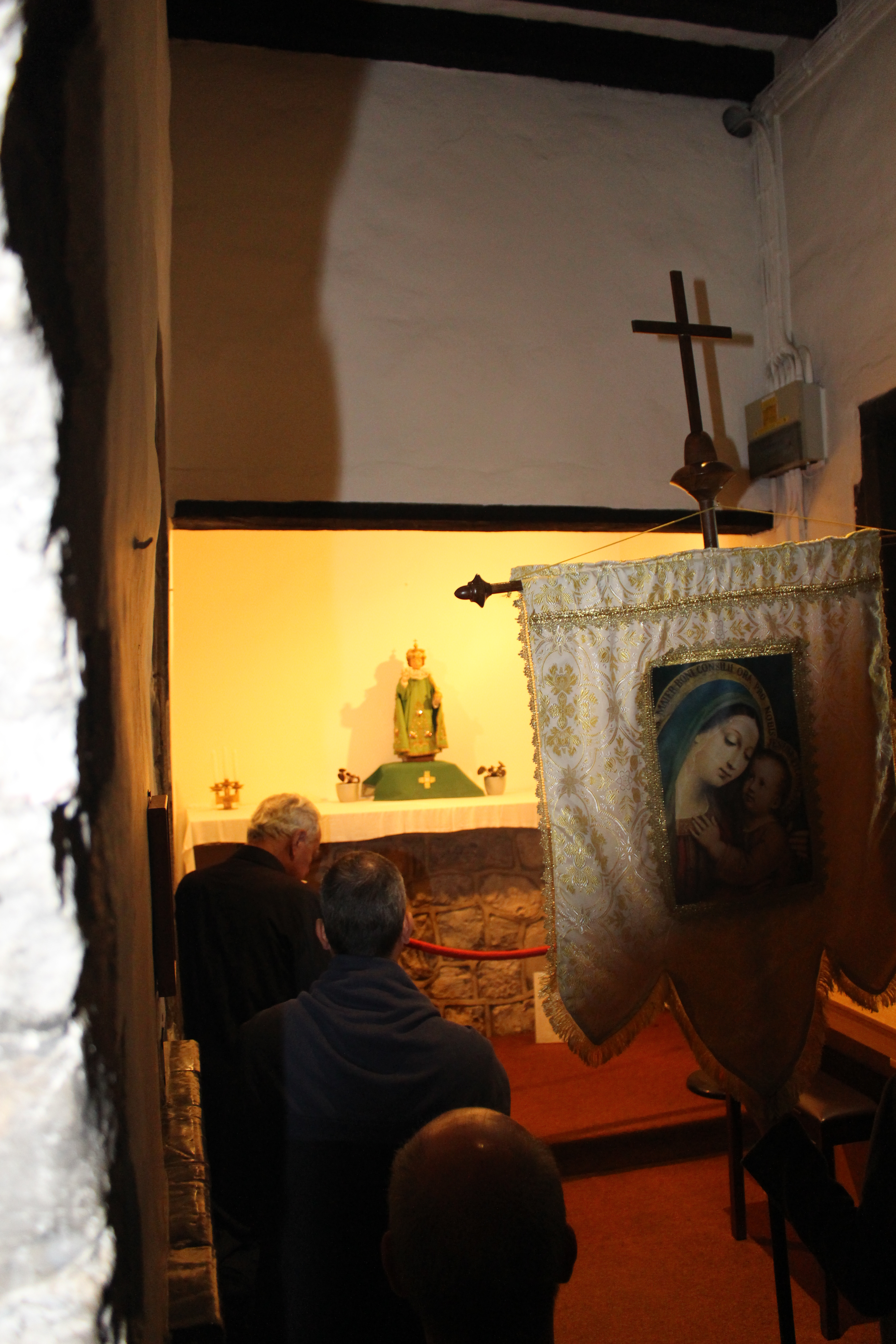 Reciting the Rosary in the Chapel of the Infant of Prague.
